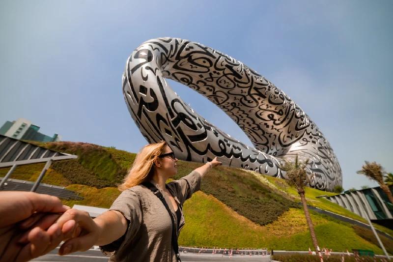 Woman tourist near Museum of The Future - TravelVerse Woman tourist near Museum of The Future - TravelVerse