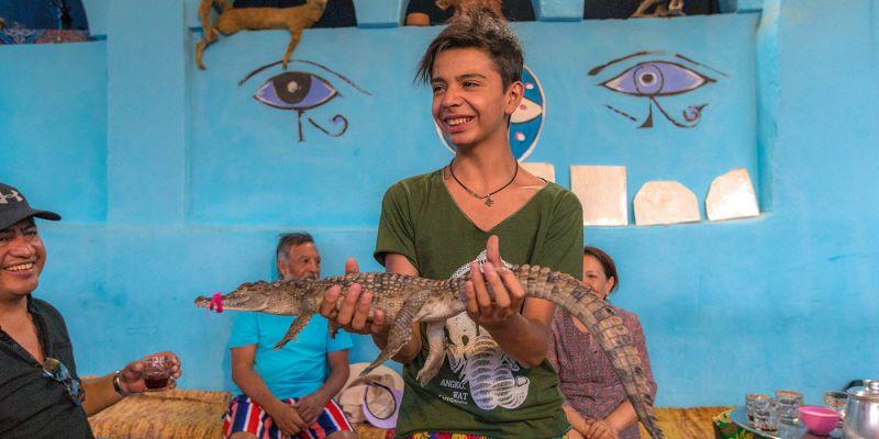 Local holding a crocodile Local holding a crocodile